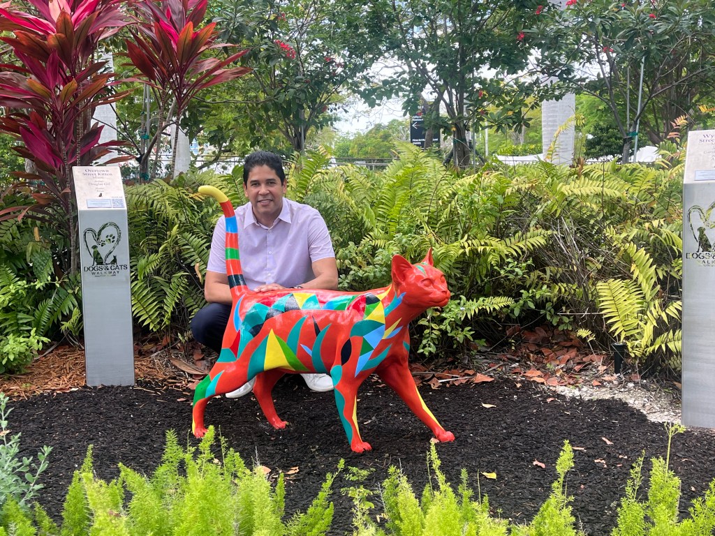 Artist Douglas Gil with his sculpture Eros at the Dogs & Cats Walkway in Bayfront Park, Miami.
